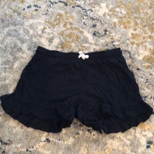 Black shorts with a ruffle on the bottom